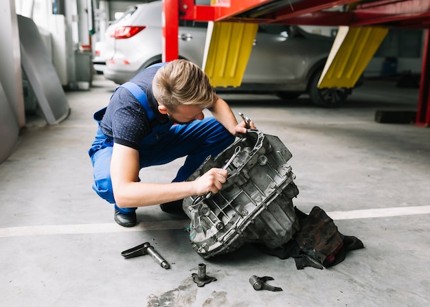 Mechanic fixing car motor