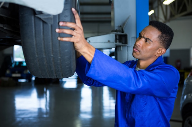 Mechanic fixing a car tyre