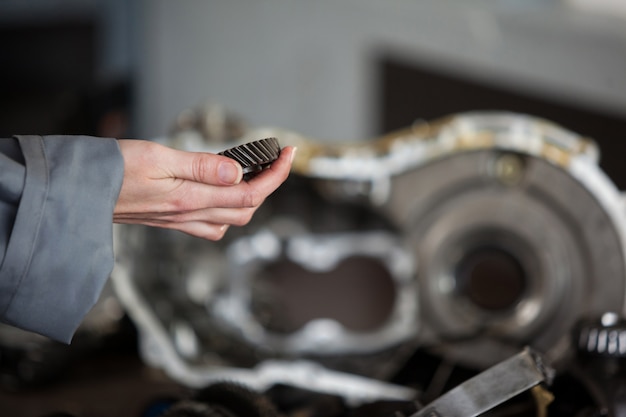 Free photo mechanic holding bevel gear