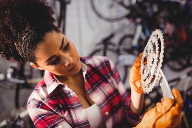 Mechanic holding a bicycle gear