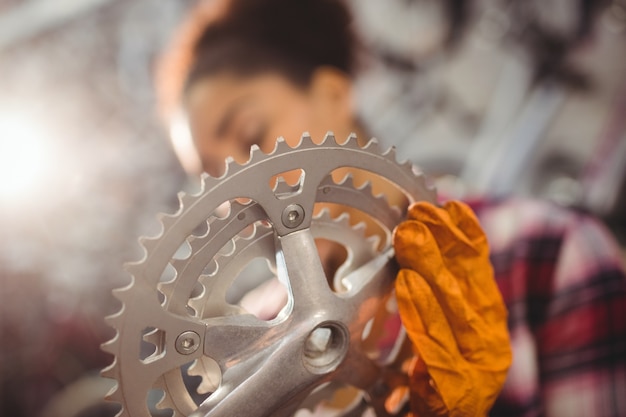 Mechanic holding a bicycle gear