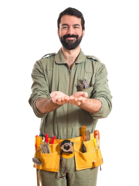 Mechanic holding something over white background