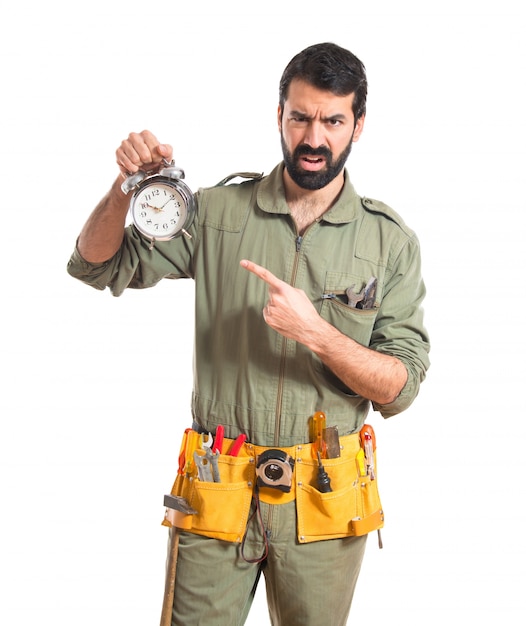 Mechanic holding vintage clock