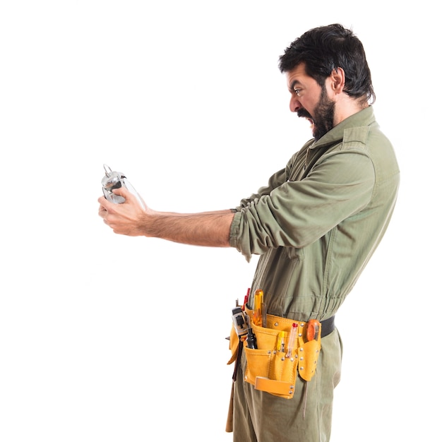 Mechanic holding vintage clock