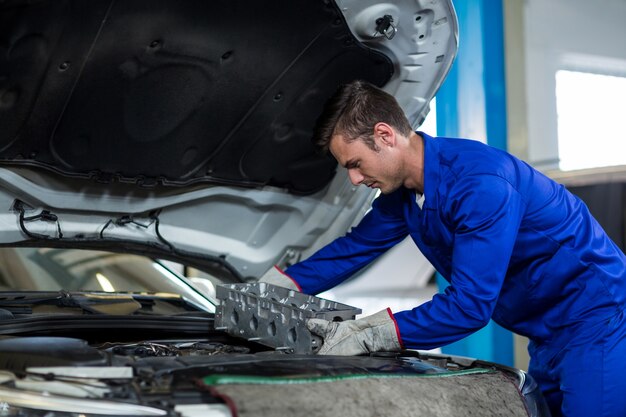 Mechanic installing car parts
