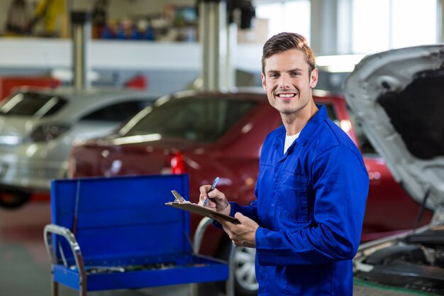 Mechanic preparing a check list