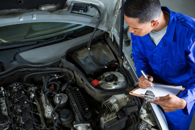 Mechanic preparing a check list