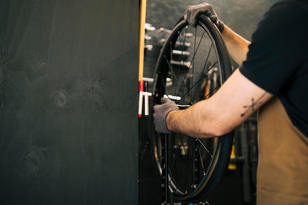 Free photo mechanic repairing a bicycle