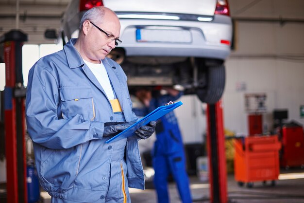 Mechanic repairing a car in the workshop