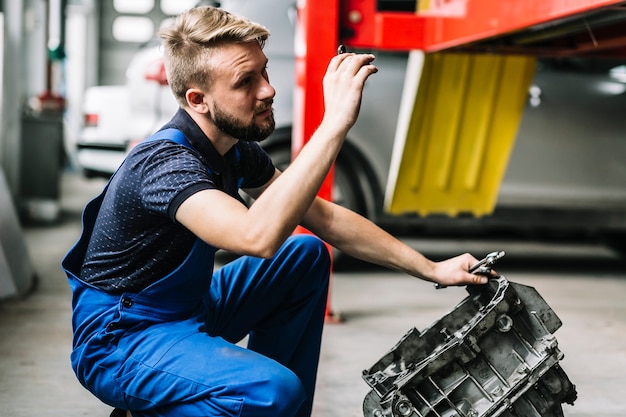 Mechanic repairing engine