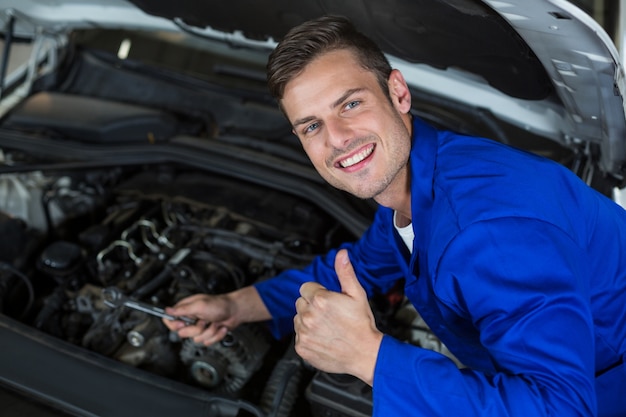 Free photo mechanic servicing a car engine