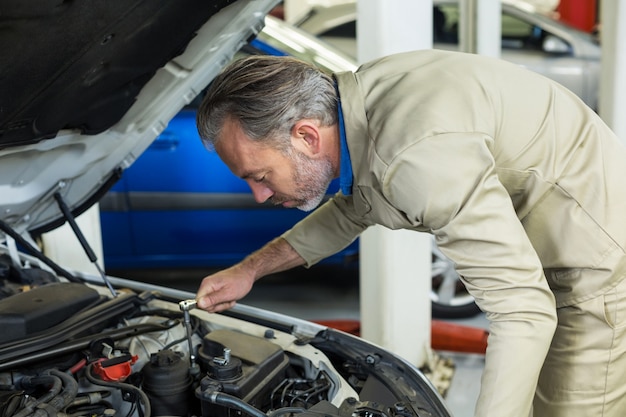 Free photo mechanic servicing a car engine