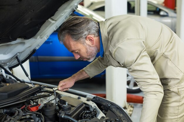 Mechanic servicing a car engine