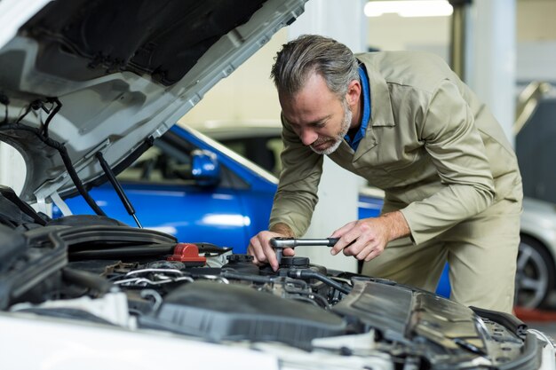 Mechanic servicing a car engine