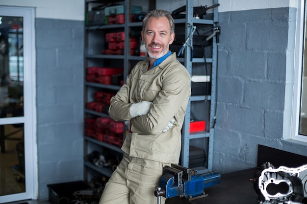 Mechanic standing with arms crossed