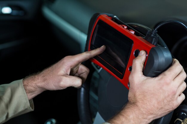 Mechanic using a diagnostic tool