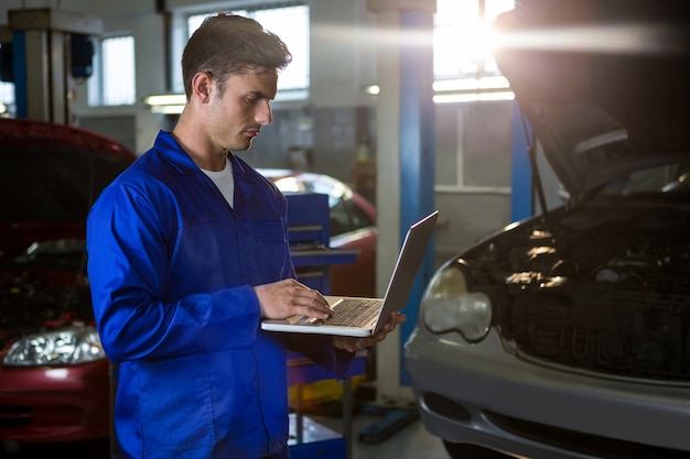 Mechanic working on laptop