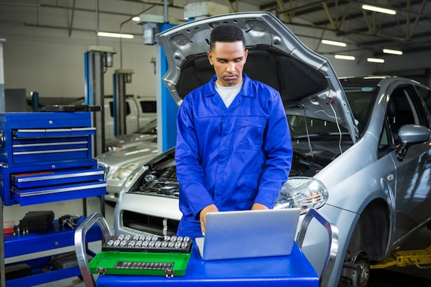 Mechanic working on laptop