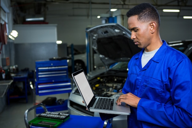 Mechanic working on laptop