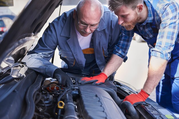 Mechanics repairing a car in the workshop