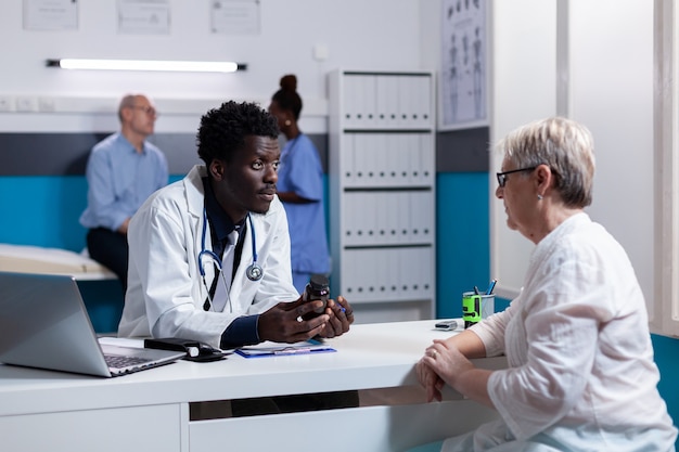 Medic of african american ethnicity with bottle of pills