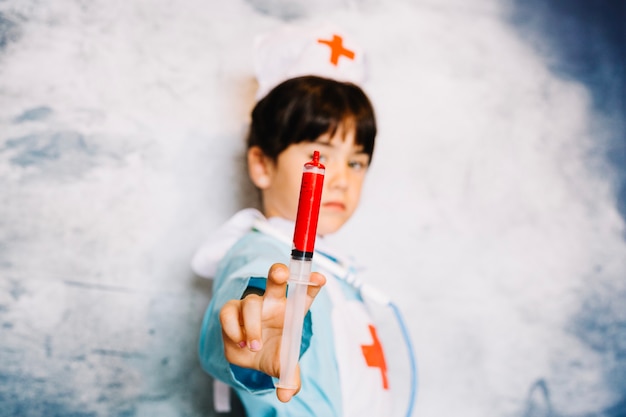 Free photo medic girl with bloody syringe