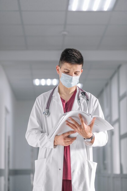 Medic man in mask with documents