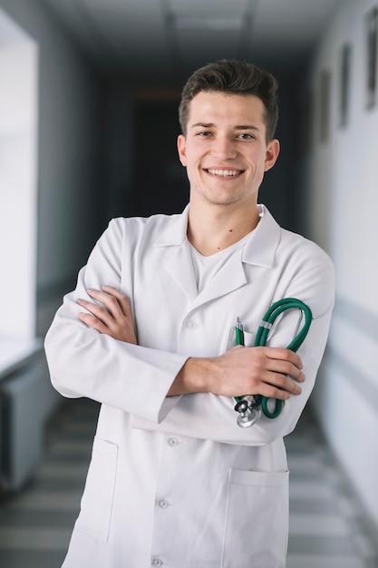 Medic man with arms crossed in hall