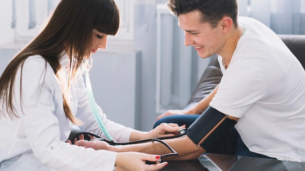 Medic measuring pressure to patient