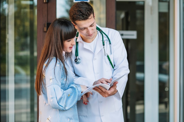 Medic and patient with documents at hospital