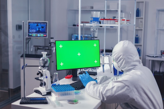 Medic uses computer with copy space available in moden laboratory during coronavirus