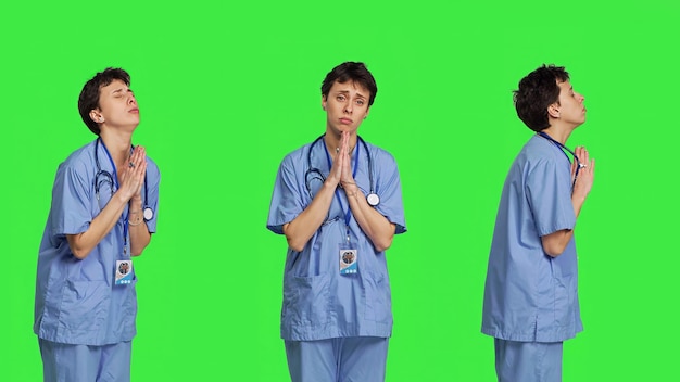 Free photo medical assistant being hopeful praying for good luck against greenscreen