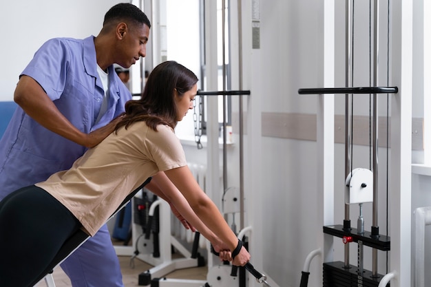 Medical assistant helping patient with physiotherapy exercises