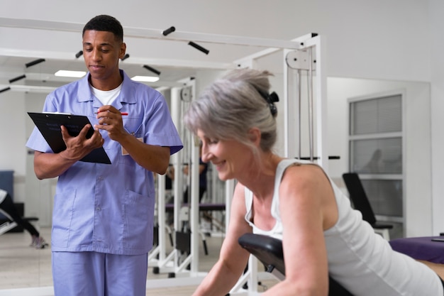 Medical assistant helping patient with physiotherapy exercises