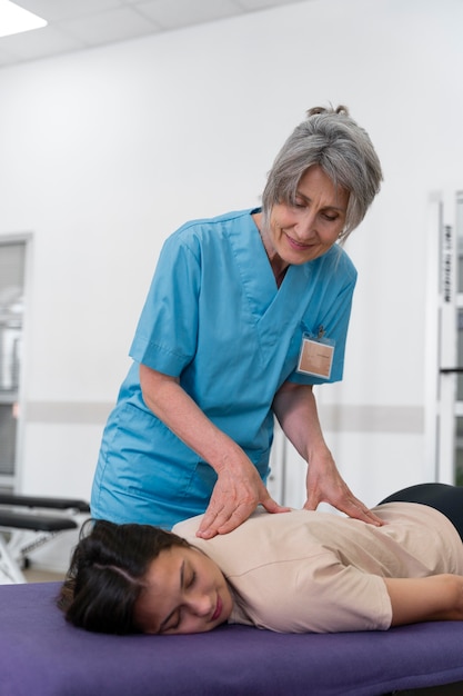 Medical assistant helping patient with physiotherapy exercises