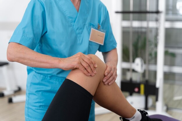 Medical assistant helping patient with physiotherapy exercises