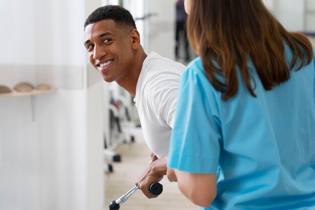 Medical assistant helping patient with physiotherapy exercises