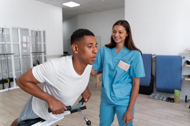 Medical assistant helping patient with physiotherapy exercises