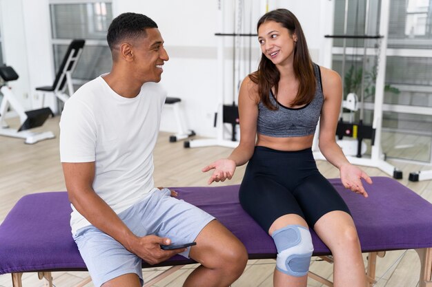 Medical assistant helping patient with physiotherapy exercises