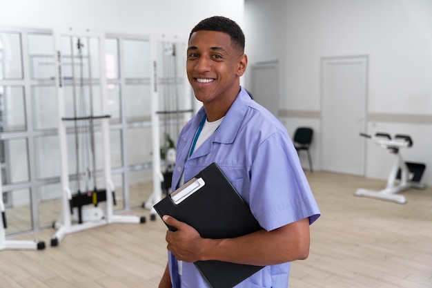 Medical assistant preparing for physiotherapy exercises