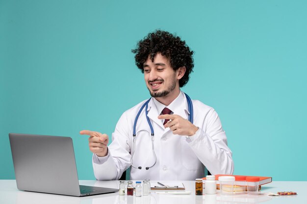 medical cute handsome doctor working on computer remotely in lab coat happy on the camera