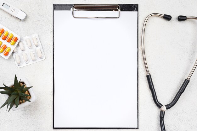 Medical desk assortment with empty clipboard