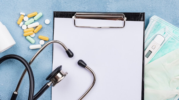 Free photo medical desk composition with empty clipboard