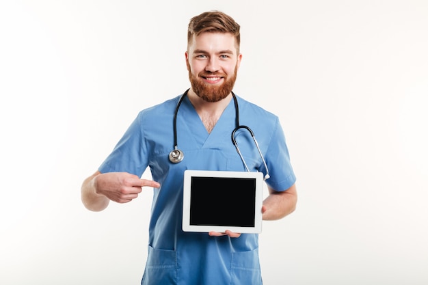 Medical doctor or nurse pointing finger at blank screen tablet