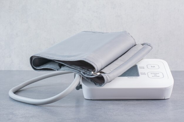 Medical electronic tonometer on marble table.