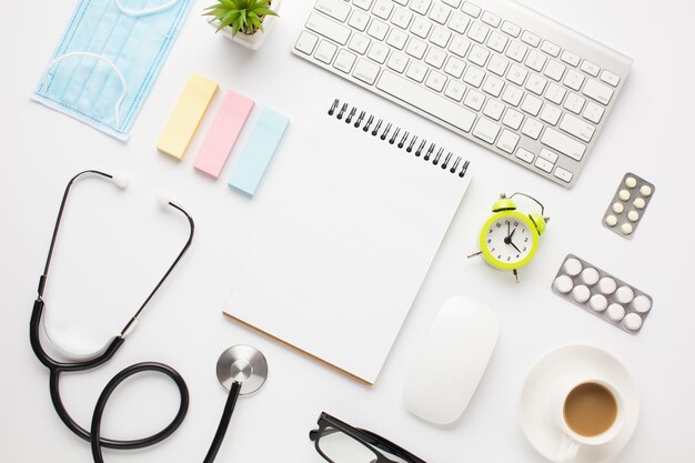 medical equipment and office supplies with coffee cup over doctor desk
