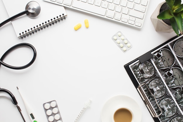 Medical equipment and repot with cup of coffee on doctor's desk