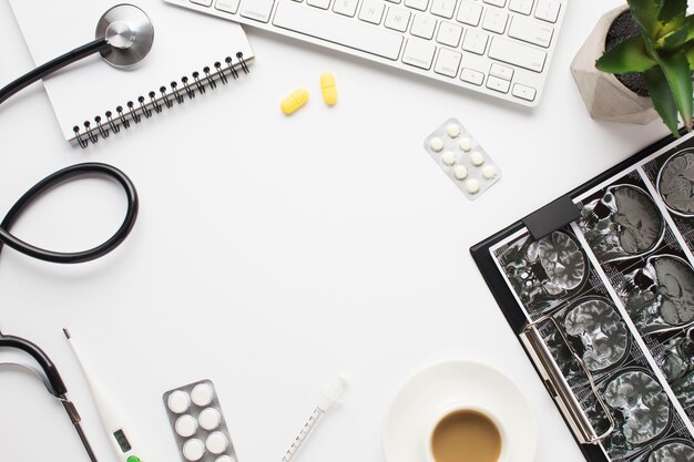 Medical equipment and repot with cup of coffee on doctor's desk