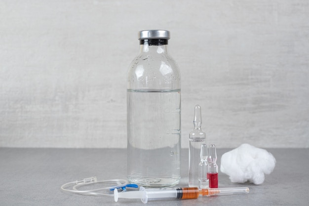 Free photo medical ethanol with cotton wool and syringe