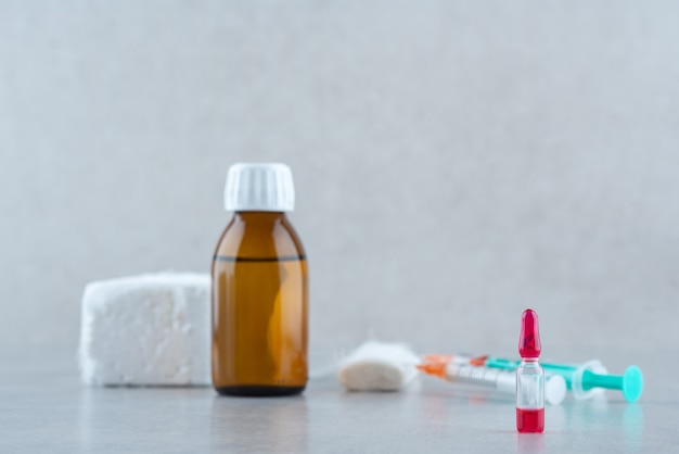 Medical ethanol with syringe on white surface